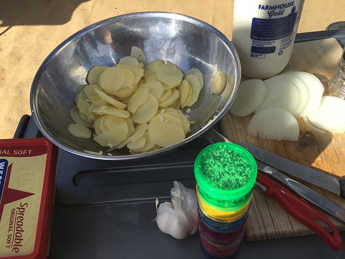 Slice the onions into rings, potatoes into discs, and dice the bacon.